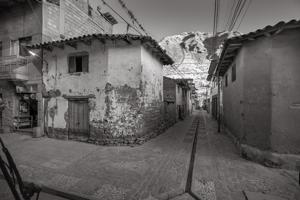 Dwelling in shadow of mountain